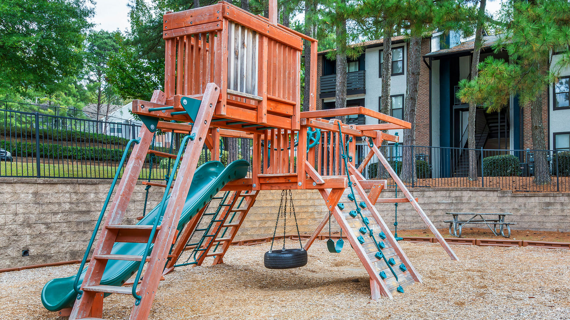 a playground set up in front of an apartment building at The  Rowen